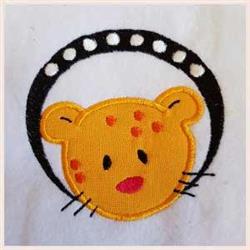 Applique cartoon-style leopard face with vibrant yellow and orange spots, framed in bold black with white dots.