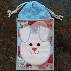 Cute bunny face design with light pink hue, white ears, and floral background in playful pastel colors for Easter.