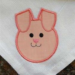 Cute bunny head in pink and black, featuring large ears and a friendly face on a white napkin, perfect for Easter celebration