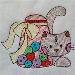 Playful cat with pink cheeks next to a colorful candy jar on soft white fabric, perfect for quilting.