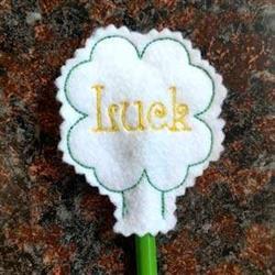 Whimsical clover with scalloped edges and 'Luck' in gold, perfect for St. Patrick's Day decorations.