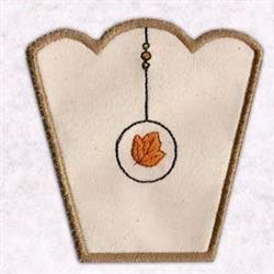 FSL decorative patch featuring a scalloped beige edge and orange leaf, embodying a simple autumn theme.