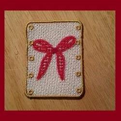 FSL red bow patch with a textured white background and gold border, perfect for playful crafting.