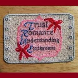 FSL embroidered patch featuring colorful text 'Trust Romance Understanding Excitement' with playful red bows.