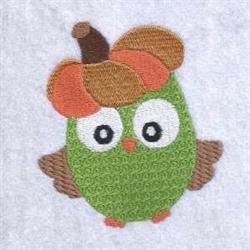 Cartoonish green owl with big eyes and pumpkin hat, perfect for playful fall decor.
