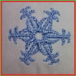 Whimsical snowflake in light blue thread, featuring intricate symmetrical designs, perfect for winter decorations.