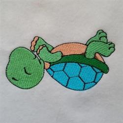 Cartoonish turtle with a blue geometric shell and light pink underbelly, lying playfully on its back.