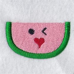 Playful watermelon slice with black eyes and heart mouth, featuring pink fabric and green edge, cheerful summer vibe.