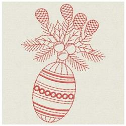 Redwork Easter egg with intricate red patterns, adorned with pinecones and leaves, perfect for festive decor.